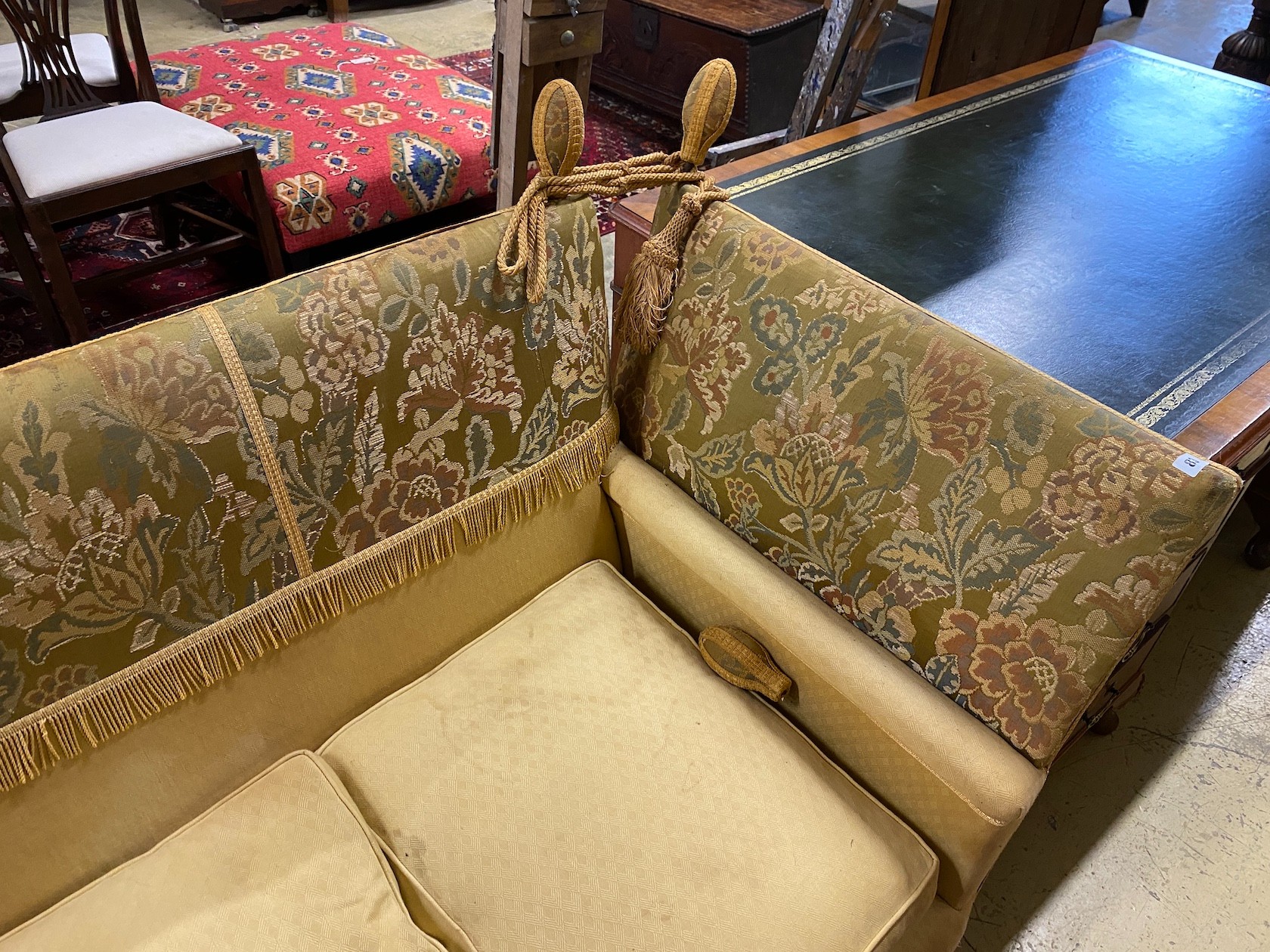 A Knole settee, upholstered in floral brocade, width 186cm, depth 80cm, height 104cm.
